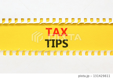 Tax tips symbol. Concept word Tax tips on beautiful white paper. Beautiful yellow paper background. Business tax tips concept. Copy space. 131429811