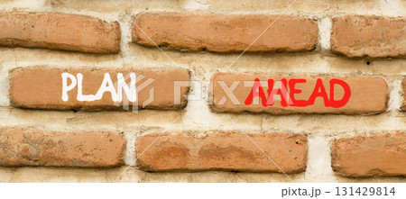 Plan ahead symbol. Concept word Plan ahead on beautiful old brown brick wall. Beautiful old brown brick wall background. Old brick wall. Business plan ahead concept. Copy space. 131429814