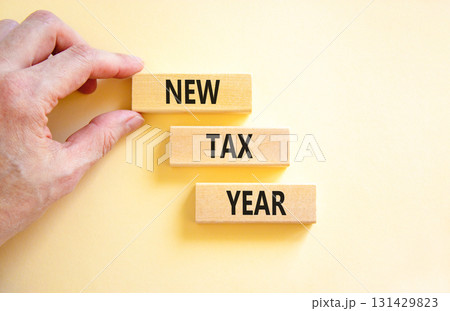 New tax year symbol. Concept words New tax year on beautiful wooden blocks. Beautiful white background. Businessman hand. Business new tax year concept. Copy space. 131429823