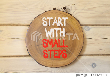 Start with small steps symbol. Concept words phrase Start with small steps on beautiful wooden circle. Beautiful wooden wall background. Business motivational Start with small steps concept Copy space Start with small steps symbol. Concept words phrase Start with small steps on beautiful wooden circle. Beautiful wooden wall background. Business motivational Start with small steps concept Copy space 131429994