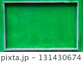 Vibrant green textured background with a rectangular frame, ideal for design projects, showcasing a lively and fresh atmosphere with ample copy space for text or graphics 131430674