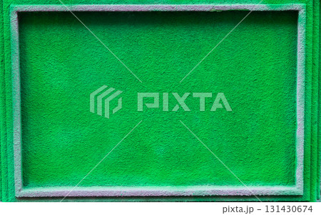 Vibrant green textured background with a rectangular frame, ideal for design projects, showcasing a lively and fresh atmosphere with ample copy space for text or graphics 131430674