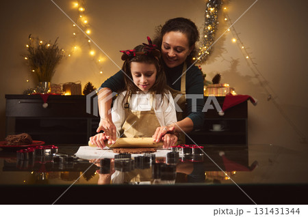 Mother And Daughter Baking Gingerbread Together During Cozy Christmas Home 131431344