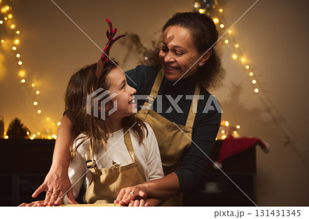 Joyful Mother And Daughter In Aprons Share Warm Christmas Moment At Home Studio Joyful Mother And Daughter In Aprons Share Warm Christmas Moment At Home Studio 131431345