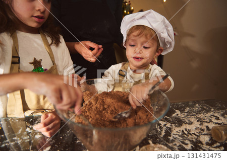 Kids Baking Gingerbread With Chef Hat Mom In Cozy Kitchen For Christmas 131431475