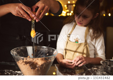 Family Baking Scene: Mother and Child Crafting Gingerbread Treats by Warm Kitchen Lights 131431482