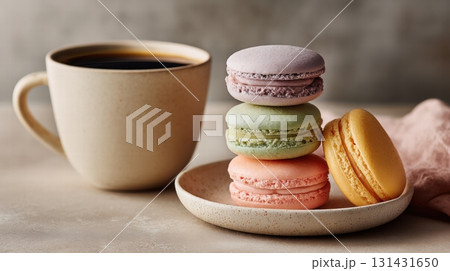 coffee and stack of colorful macarons on a pale ceramic plate 131431650