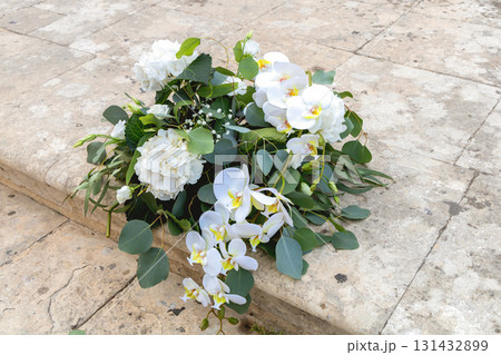 Roses orchids hydrangeas bouquet on vintage stairs Roses orchids hydrangeas bouquet on vintage stairs 131432899