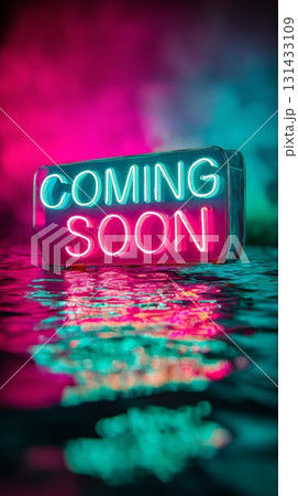 Neon sign with the words COMING SOON reflecting on vibrant water surface 131433109