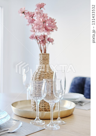 Elegant table setting with wine glasses and floral decor Elegant table setting with wine glasses and floral decor 131433532