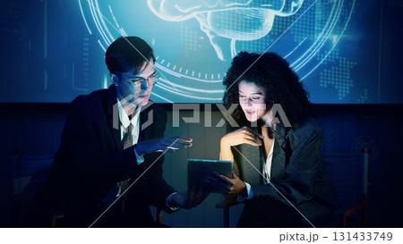 Business team discussing and using technology artificial intelligence with digital Ai assistant. Futuristic innovation AI technology collaboration and ideas for future. Business Tech Startup meeting. Business team discussing and using technology artificial intelligence with digital Ai assistant. Futuristic innovation AI technology collaboration and ideas for future. Business Tech Startup meeting. 131433749