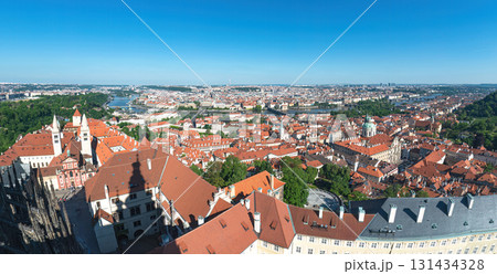 Panoramic view of Prague embracing the Vltava river and its bridges under a clear blue sky 131434328