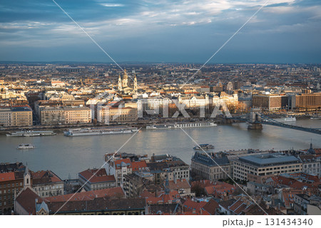 The sun is setting over the Danube river and the pest side of Budapest with the chain bridge and St Stephen Basilica The sun is setting over the Danube river and the pest side of Budapest with the chain bridge and St Stephen Basilica 131434340