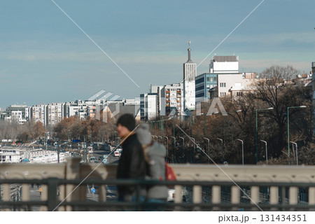 Tourists walking on a bridge and enjoying the view of Budapest, Hungary Tourists walking on a bridge and enjoying the view of Budapest, Hungary 131434351