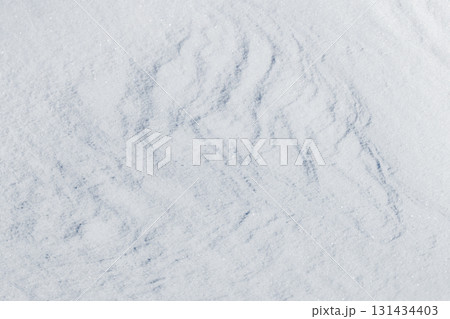 Relief snow surface with pale blue shadows creates a calm, wintry backdrop Relief snow surface with pale blue shadows creates a calm, wintry backdrop 131434403