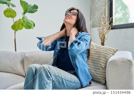 Young woman holding her neck with her hands, muscle pain 131434496