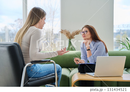 Female counselor psychologist working with young woman patient 131434521