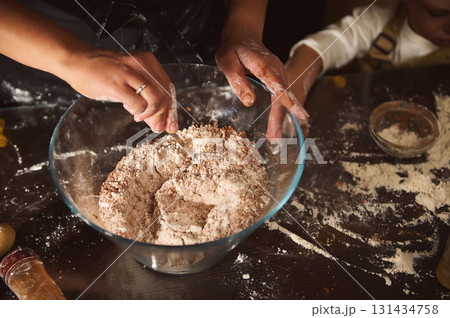 Family Baking Together: Hands Mixing Flour in Large Glass Bowl for Fresh Dough Family Baking Together: Hands Mixing Flour in Large Glass Bowl for Fresh Dough 131434758