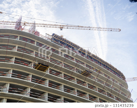 Construction of a modern high-rise building. Sides on the floors. Concrete frame of a building under construction. Construction in progress Construction of a modern high-rise building. Sides on the floors. Concrete frame of a building under construction. Construction in progress 131435239