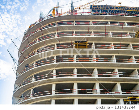 Construction of a modern high-rise building. Sides on the floors. Concrete frame of a building under construction.  Construction in progress 131435244