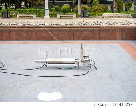 Empty fountain in a city park. Draining the fountain. Cleaning the fountain with a hose. Empty fountain in a city park. Draining the fountain. Cleaning the fountain with a hose. 131435257