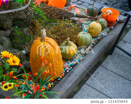 Decorations for Halloween on the street near the restaurant. Pumpkins are placed near the tree. Restaurant patio decoration. Painted multi-colored pumpkins. All Saints' Day. The holiday is Decorations for Halloween on the street near the restaurant. Pumpkins are placed near the tree. Restaurant patio decoration. Painted multi-colored pumpkins. All Saints' Day. The holiday is 131435643
