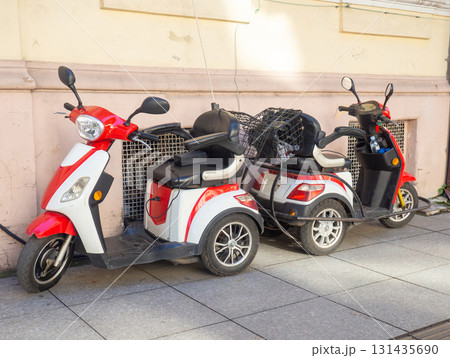 Three-wheeled electric mopeds. Comfortable moped for the city. Compact vehicle 131435690