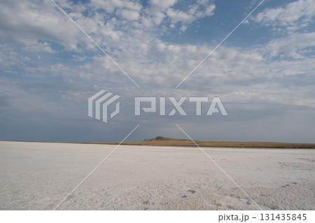 Horizontal landscape with salt pillars of Lake Baskunchak and Mount Bogdo in the background at sunset. Astrakhan region, Russia 131435845