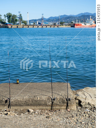 Fishing rods on the seashore. Fishing. Waiting for a bite. Bottom fishing. 131435953