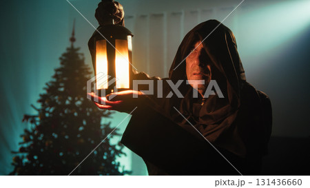 Religious Poor Hooded Man In Mysterious Room With Christmas Tree Religious Poor Hooded Man In Mysterious Room With Christmas Tree 131436660