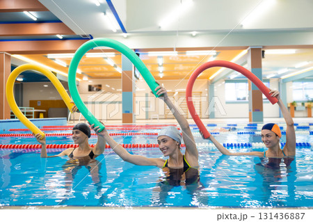 Women training with aqua noodles Women training with aqua noodles 131436887