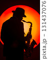 silhouette of saxophone player with orange backdrop silhouette of saxophone player with orange backdrop 131437076