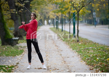 Athletic young woman taking a breath and relaxing after jogging and stretching. Woman Training and Workout Exercises On Street. Athletic young woman taking a breath and relaxing after jogging and stretching. Woman Training and Workout Exercises On Street. 131437230