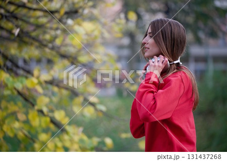 Athletic young woman taking a breath and relaxing after jogging and stretching. Woman Training and Workout Exercises On Street. Athletic young woman taking a breath and relaxing after jogging and stretching. Woman Training and Workout Exercises On Street. 131437268