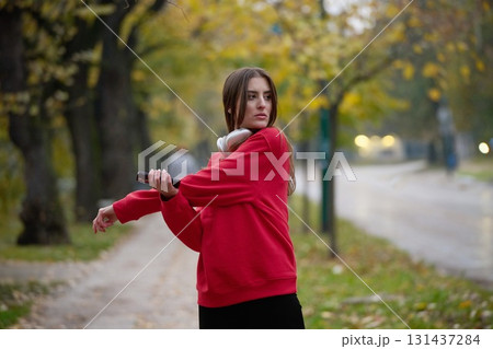 Athletic young woman taking a breath and relaxing after jogging and stretching. Woman Training and Workout Exercises On Street. 131437284