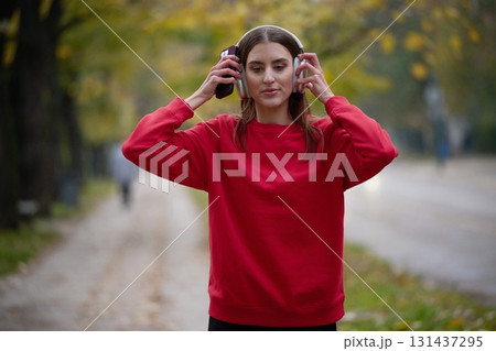 Athletic young woman taking a breath and relaxing after jogging and stretching. Woman Training and Workout Exercises On Street. 131437295
