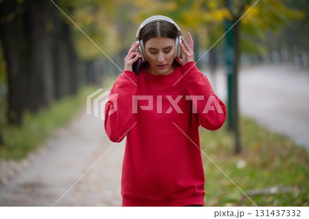 Athletic young woman taking a breath and relaxing after jogging and stretching. Woman Training and Workout Exercises On Street. 131437332