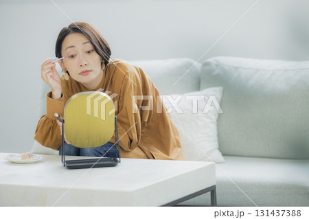 リビングで鏡を見る女性 131437388