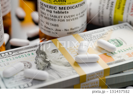 Prescription Medicine Bottles and Pills Next To Stacks of 100 Dollar Bills. Prescription Medicine Bottles and Pills Next To Stacks of 100 Dollar Bills. 131437582