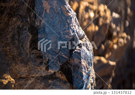 Lava formations, stones, black basalt in the rocks closeup on a volcano terrain. Lava formations, stones, black basalt in the rocks closeup on a volcano terrain. 131437812
