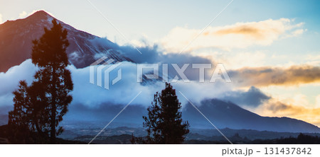 A volcano Teide and mountains among clouds at sunset. A volcano Teide and mountains among clouds at sunset. 131437842