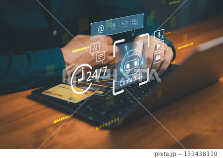 Hands typing on laptop with virtual AI chatbot contact interface, 24/7 customer support icons, and credit card, representing online service, payment, and artificial intelligence assistance. 131438110