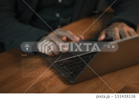 Close-up of a hand pointing at laptop with AI search bar and data visualization, representing artificial intelligence, big data analysis and smart technology innovation for digital solutions. 131438116