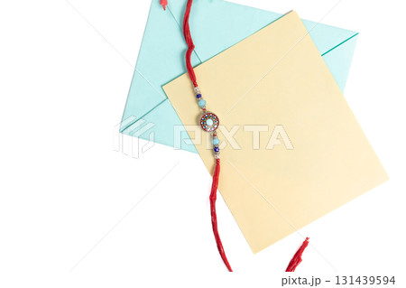 Traditional Rakhi with greeting card and envelope on white background 131439594