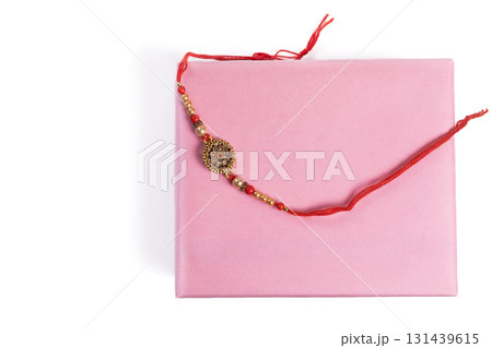 An elegant Rakhi in a pink gift box celebrating sibling bonding and festive traditions. 131439615