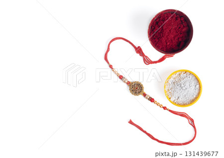 Rakhi bangle with red kumkum and white powder bowl for the festival Raksha Bandhan. 131439677