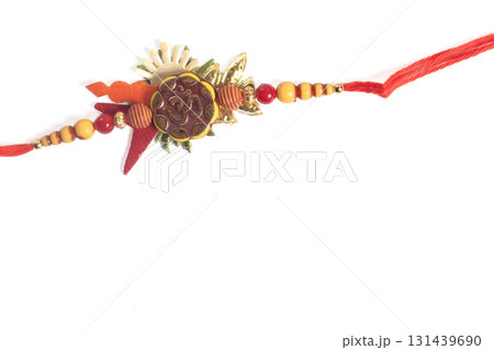 Colorful Rakhi bracelet with beads and Om charm on red string as a festival gift. 131439690