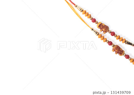 Colorful Rakhi bangle made of red and orange beads for Raksha Bandhan celebration 131439709
