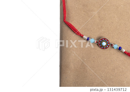 Colorful beaded bracelet with a round center pendant on a red cord 131439712