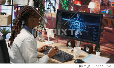 Overjoyed programmer happily clapping hands after finishing maintenance on neural networks. IT expert doing ecstatic fist pump in air hand gesture after successful checkup on AI systems, camera B 131439898